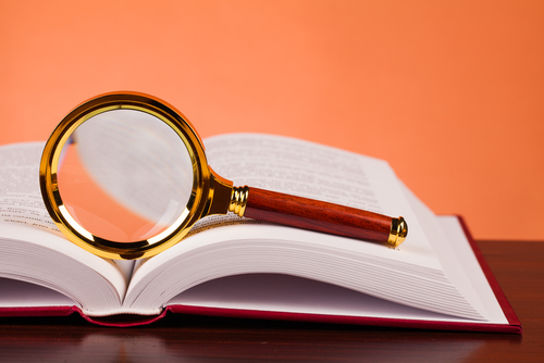 magnifying glass with book